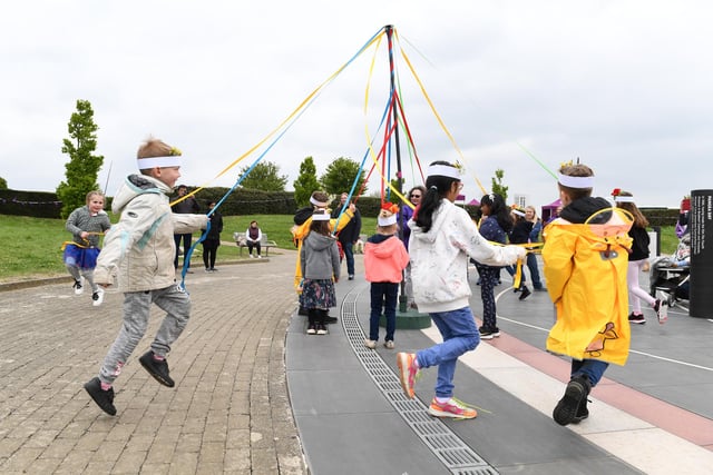 Children join in the maypole dancing