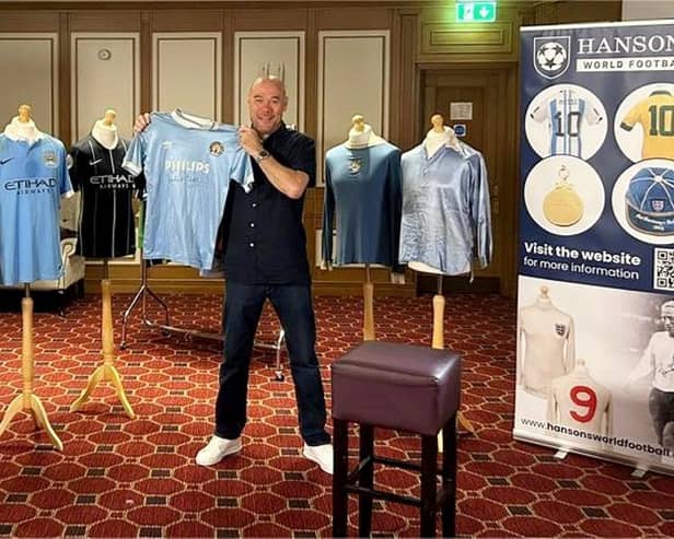 Manchester City fan Mark McCarthy with Manchester City collection that is up for sale