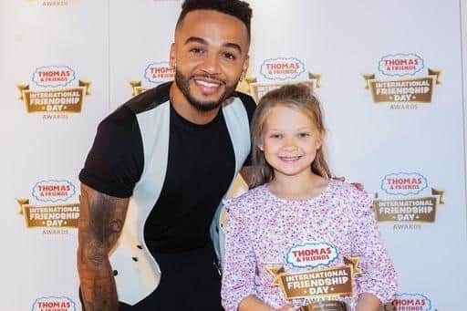 Millie, 8, from Milton Keynes received her award from JLS star Aston Merrygold