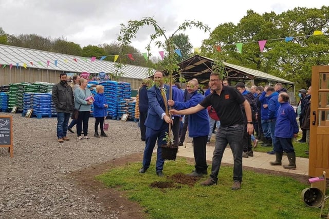 Greg Smith MP plants a tree with general manager Matt Philcox and adult care client Daniel