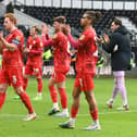 MK Dons applaud the travelling support after their 1-1 draw with Derby County on Easter Monday