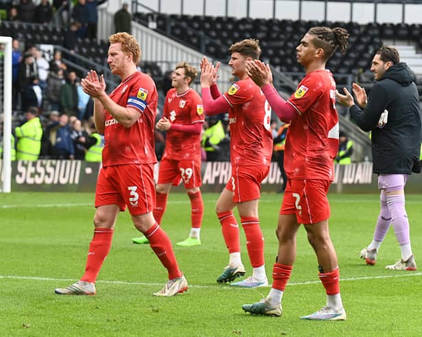 MK Dons applaud the travelling support after their 1-1 draw with Derby County on Easter Monday