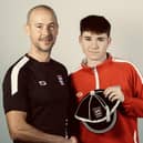 Juud Farrant receives his first England cap from team manager Darin Killpartrick