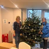 World Vision and Willen Hospice staff with the decorated tree.