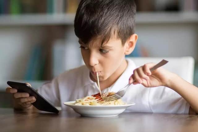 Almost 50 per cent of children eat their meal while playing on a phone or tablet, research has shown