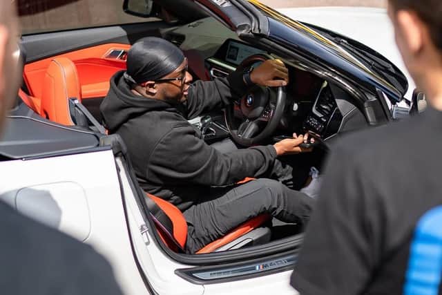 A proud petrol head showing off his car