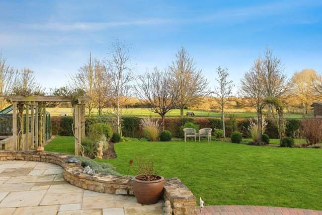 The attractive landscaped garden comprises of large patio terrace and lawn, enclosed by timber fencing and hedging. It also features mature hedging, bushes and shrubs.
