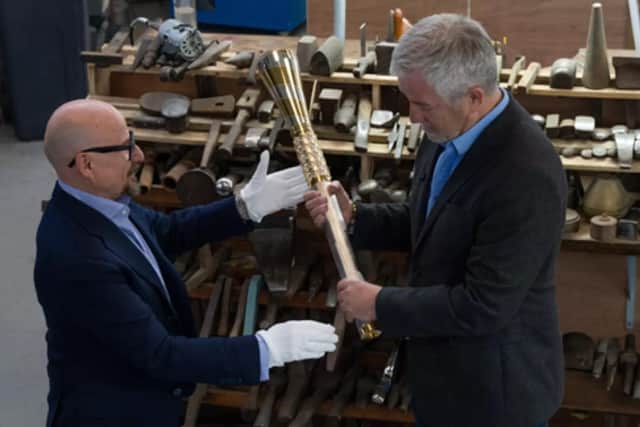 Charity co-founder Mike McCarthy, right, receives the Baton from Thomas Lyte CEO Kevin Baker