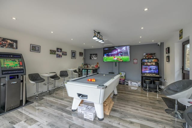 The double garage has been converted to feature a spectacular games room space, currently housing a pool table, arcade games and a bar (available via separate negotiation)