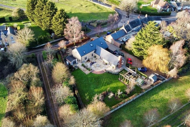 Aerial view of this stunning stone property set on 3/4 of an acre in High Street, Haversham.