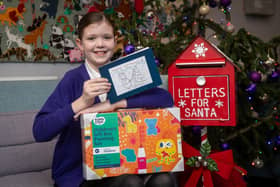 BN - 1512202313 - Chloe with one of her designed Christmas cards and prize