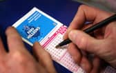 Filling out a lottery ticket.