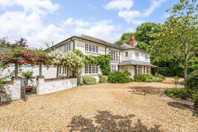 The property is approached via two sets of electric gates opening to a gravel carriage driveway providing parking for several cars and leading to the detached double garage. The drive is bordered by well-tended beds containing flowering shrubs and trees.