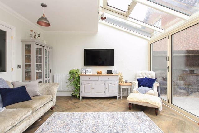 The light filled sitting room features double glazed bi folding doors opening to the rear garden