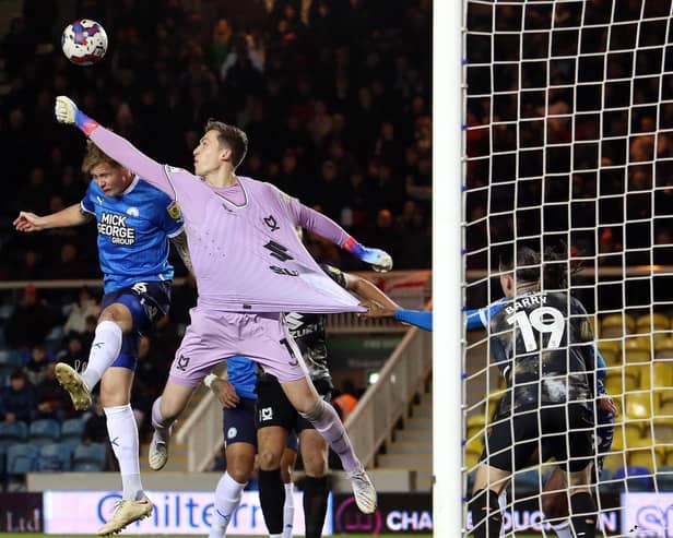 Frankie Kent of Peterborough United challenges for the ball with Jamie Cumming of Milton Keynes Dons - Mandatory by-line: Joe Dent/JMP - 29/12/2022 - FOOTBALL - Weston Homes Stadium - Peterborough, England - Peterborough United v Milton Keynes Dons - Sky Bet League One