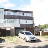 The house has three storeys and a garage