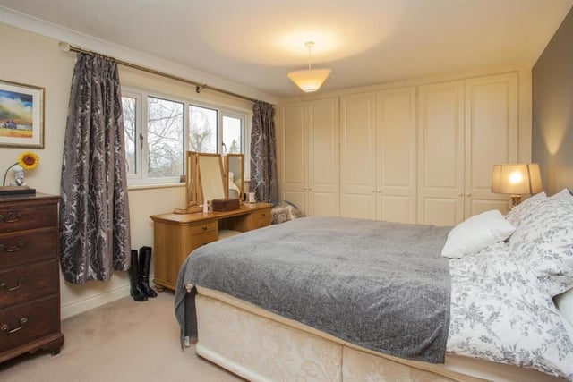 Bedroom 1 has a range of built-in wardrobes and oak door leading to the en-suite which is fitted with a white suite including a fully tiled double shower cubicle with glass sliding doors.