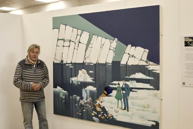 The artist with his painting about global warming, melting glaciers and pollution