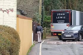 A John Lewis truck negotiates the notorious double bend on Walton Road