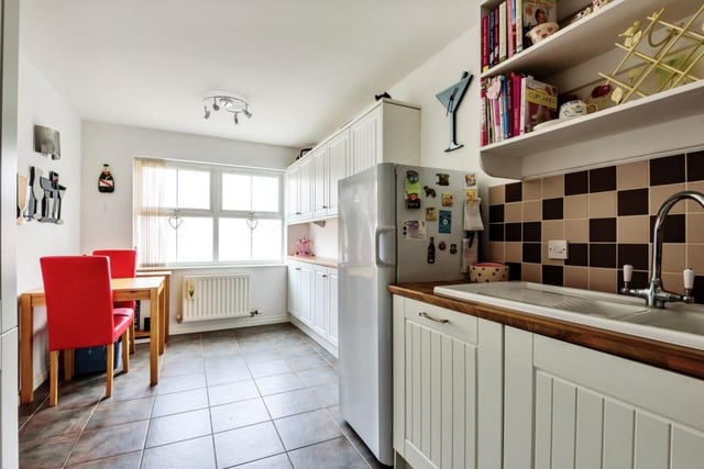 The spacious re-fitted kitchen boasts a range of units with integrated appliances