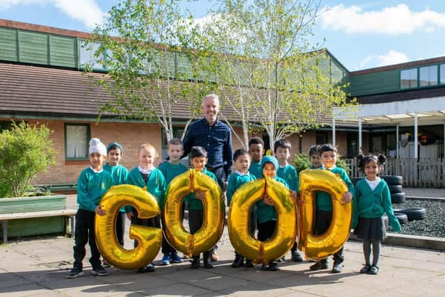 Headteacher with some pupils from the school