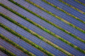Library picture of a solar farm (Photo by Adrian DENNIS / AFP via Getty Images)
