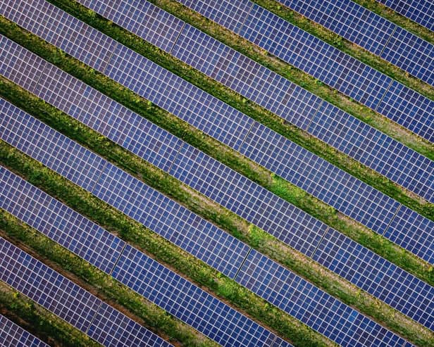Library picture of a solar farm (Photo by Adrian DENNIS / AFP via Getty Images)