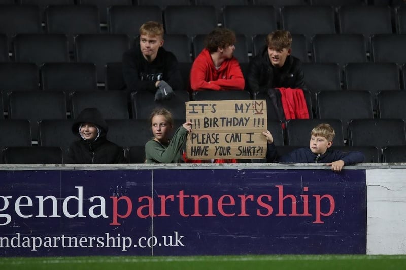 Young Milton Keynes Dons fans ask for a shirt during the game with Fleetwood Town on September 28, 2021.