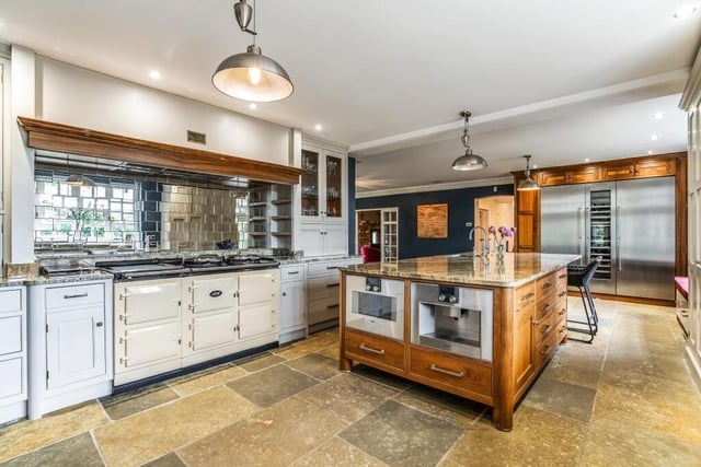 This magnificent fitted kitchen has it all - with range cooker, integrated appliances including wine cooler and island with marble effect worktops.