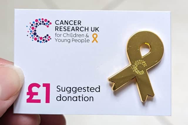 You can wear a gold ribbon badge which can be found in Cancer Research UK stores.