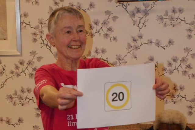Resident Ruth Legh-Smith presents action planned to reduce car speeds to 20mph on Fishermead estate