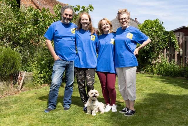 From left, Derek pictured with Anna and her mother Halyna, who are both living with Derek at his Willen home. Also pictured is Derek's wife Fancesca, and Norman, the dog.