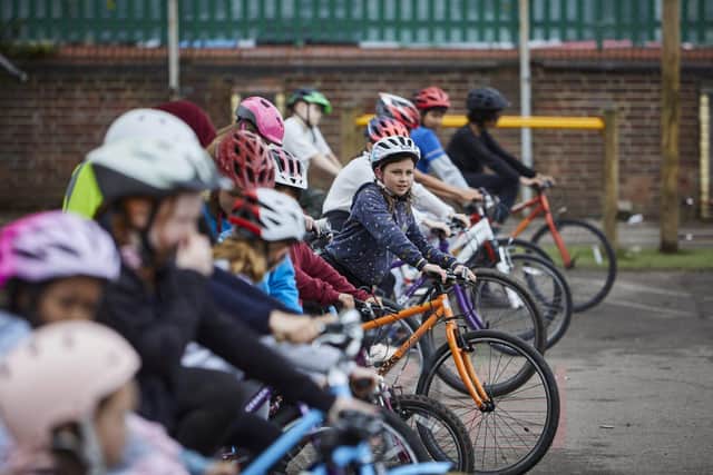 Children learn cycle skills on the playground during Level 1