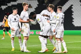 MK Dons celebrate Matt Dennis' goal which put them 2-0 up against Newport County on Tuesday night. Darragh Burns and Will Grigg also scored in the Papa John's Trophy win