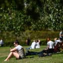 People enjoying a park on a warm day.