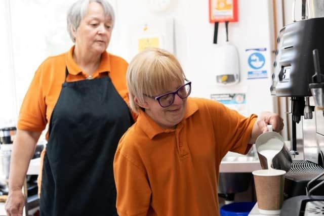 Adult care client helping in The Potting Shed Cafe at Thrift Farm