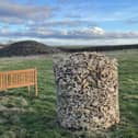 Stone gabion for engraved memorial leaves in the ground of the Barrow