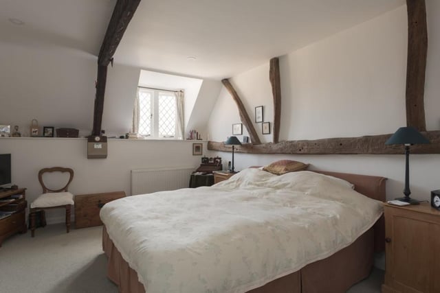 The main bedroom with feature exposed beams offers an adjacent Jacuzzi bathroom