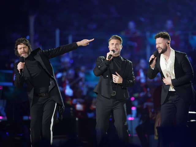 Howard Donald and Gary Barlow of Take That, perform with Callum Scott (right) on stage during the Coronation Concert