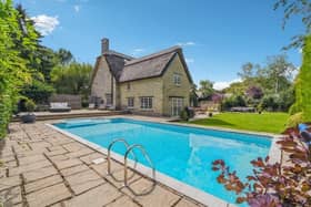 The property has been updated to feature a two-storey extension to create a home with both history and character, and give it a modern feel. Outside the driveway leads to a stone built garage feauring a gym and sauna area. The private rear garden has well tended grounds and features a heated swimming pool.
