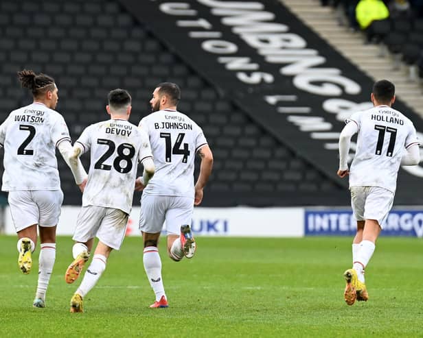 MK Dons celebrate Bradley Johnson's late equaliser against Burton Albion