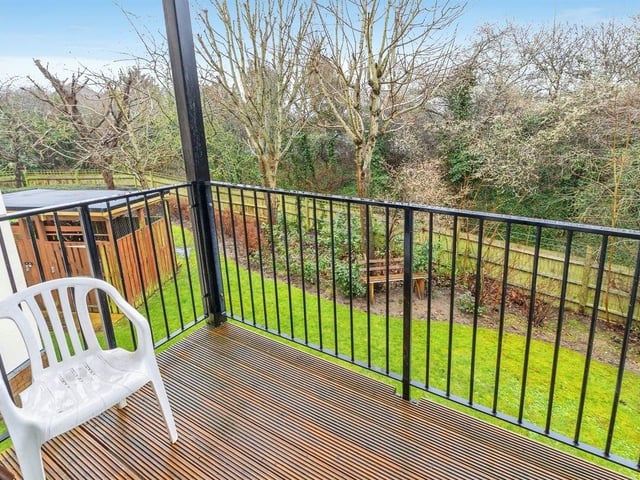 The double glazed patio door leads to a balcony overlooking a garden area.