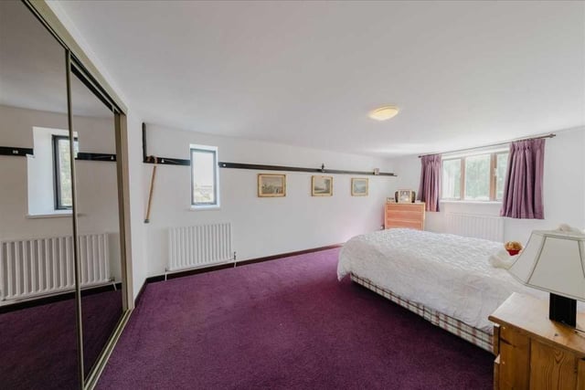 One of the spacious four bedrooms features fitted wardrobes with sliding mirrored doors