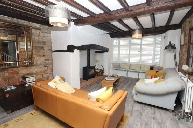 A sitting room, located to the front, has a large bay window incorporating window seat, an Inglenook fireplace incorporating a bioethanol stove, exposed wall and ceiling timbers and exposed brickwork. Doorway to the kitchen