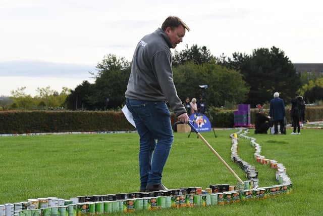 Checking  all the cans of food were in perfect in order so the world record could be broken