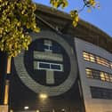 The distinctive Take That logo has appeared in lights on the wall of Stadium MK, dropping a strong hint that the band will perform there next year