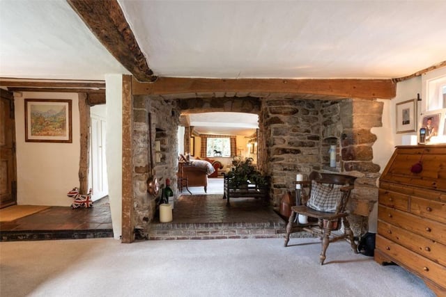 The entrance hall with feature exposed beams and fireplace