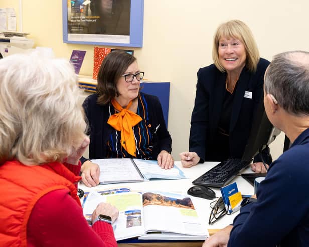 Dame Irene and Anita Luscombe, helping a couple arrange a fly-drive itinerary in the western USA.