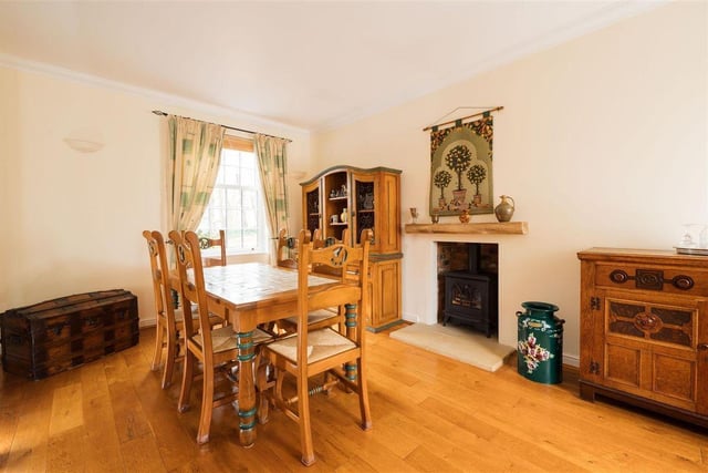 The dining room includes a fireplace with a gas living flame wood-burning stove makes for some fine fire-side dining.