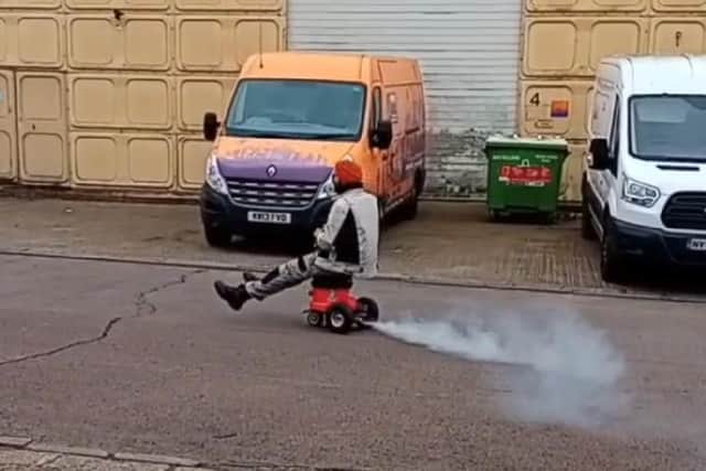 Allan Gallop rides his motorised Henry Hoover proudly around Milton Keynes